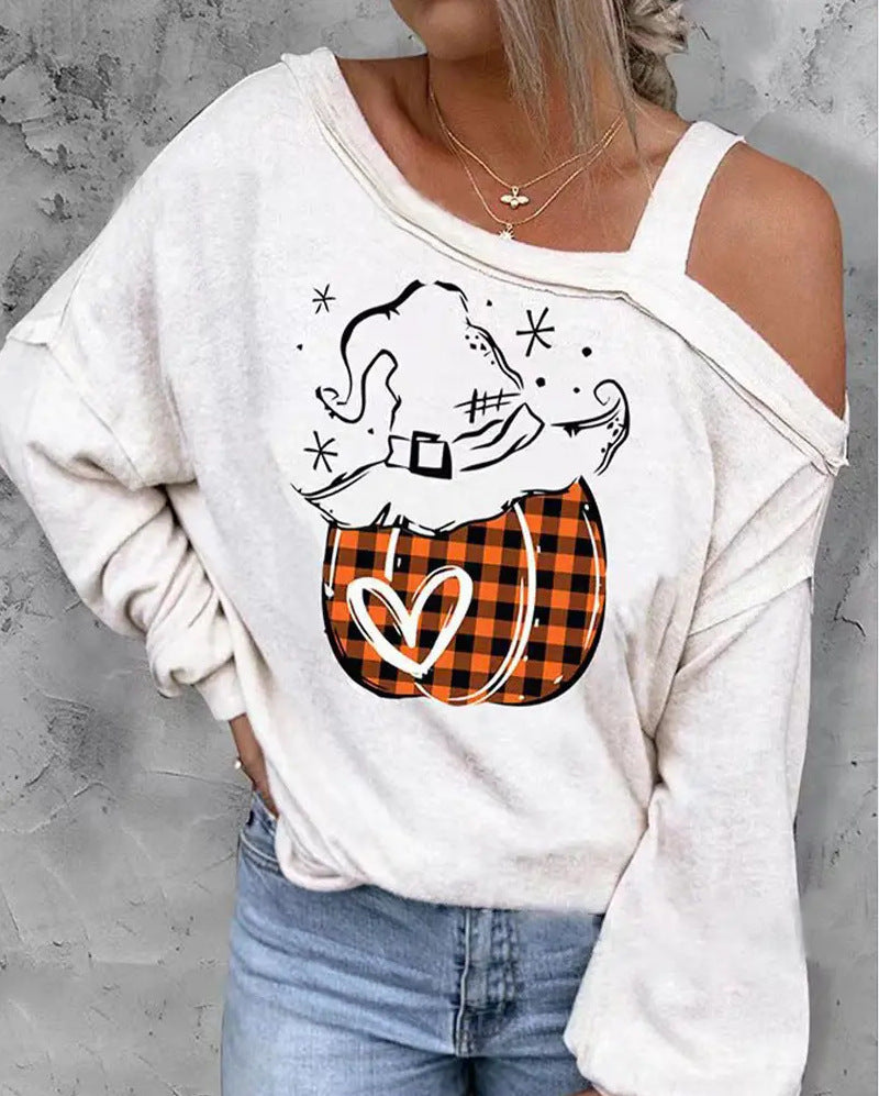 White sweatshirt with Halloween-themed design featuring a witch hat and plaid pocket on a gray background.