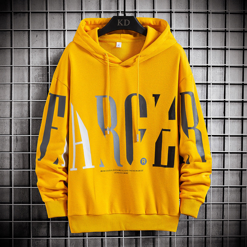 A yellow hooded pullover with bold black letter print, displayed on a hanger against a grey tiled background.