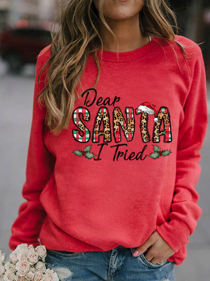 Red sweatshirt with 'Dear Santa I Tried' text and holly leaves, worn by a person.