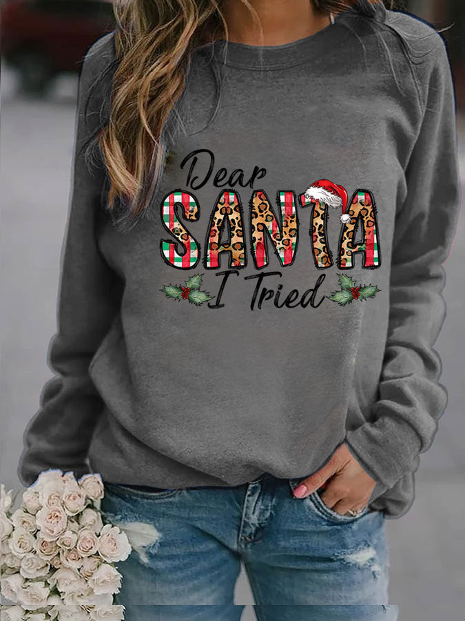 Gray sweatshirt with 'Dear Santa I Tried' text and Christmas-themed design, worn by a person.