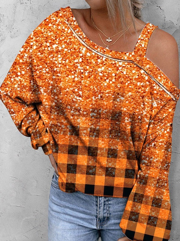 Person wearing an orange and black checkered top with a plain background