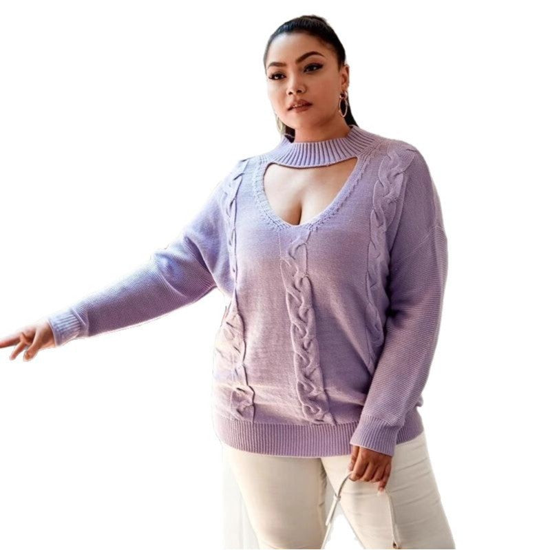 A plus-size model wearing a purple v-neck pullover with an abstract pattern and a functional front pocket.