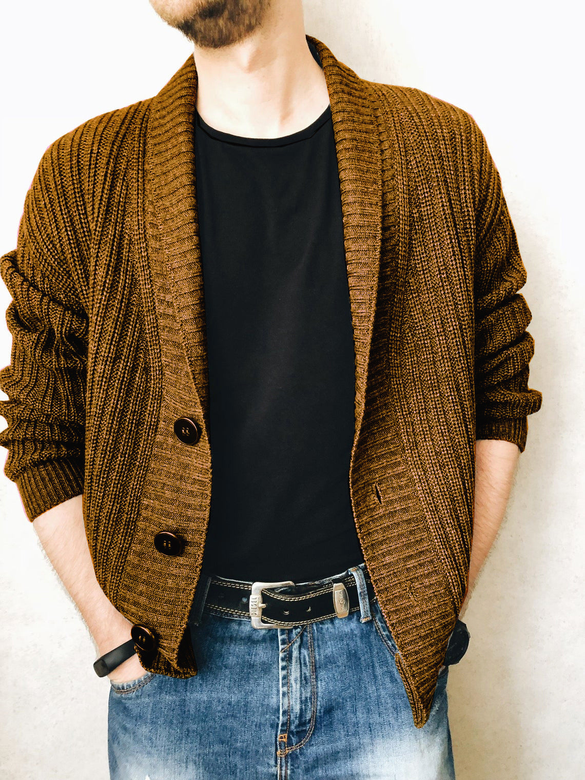 A person wearing a brown Urban Knit V-Neck Cardigan over a black t-shirt and blue jeans.