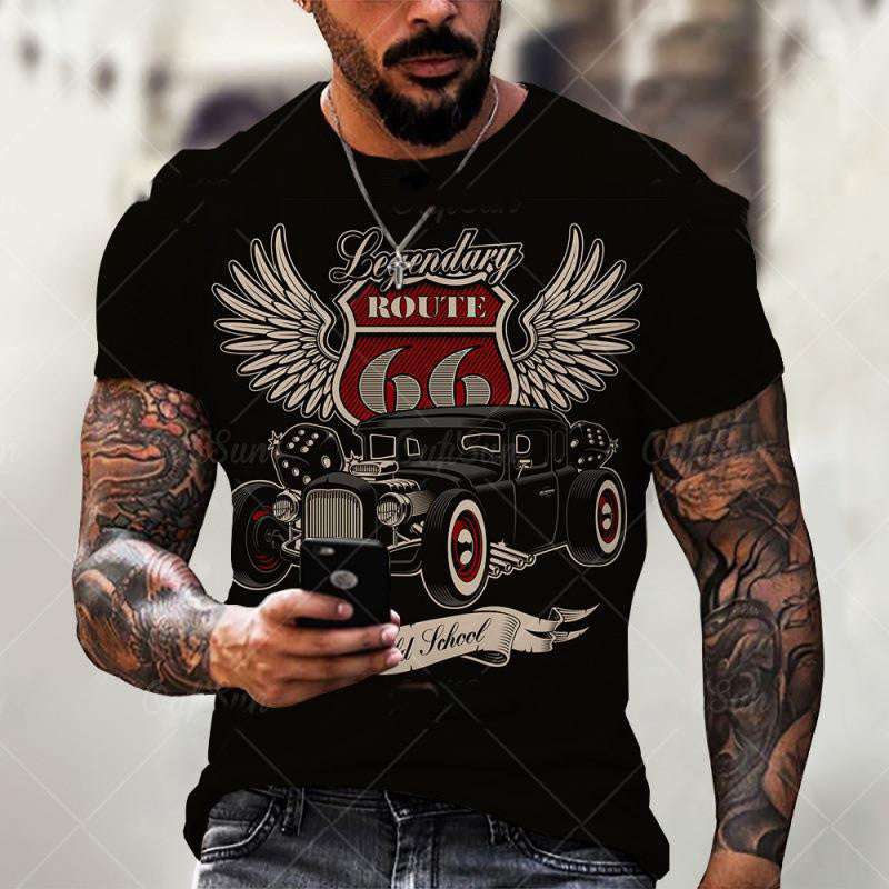 A person with tattoos wearing a black short-sleeve t-shirt with a playing card motif of the King of Spades.