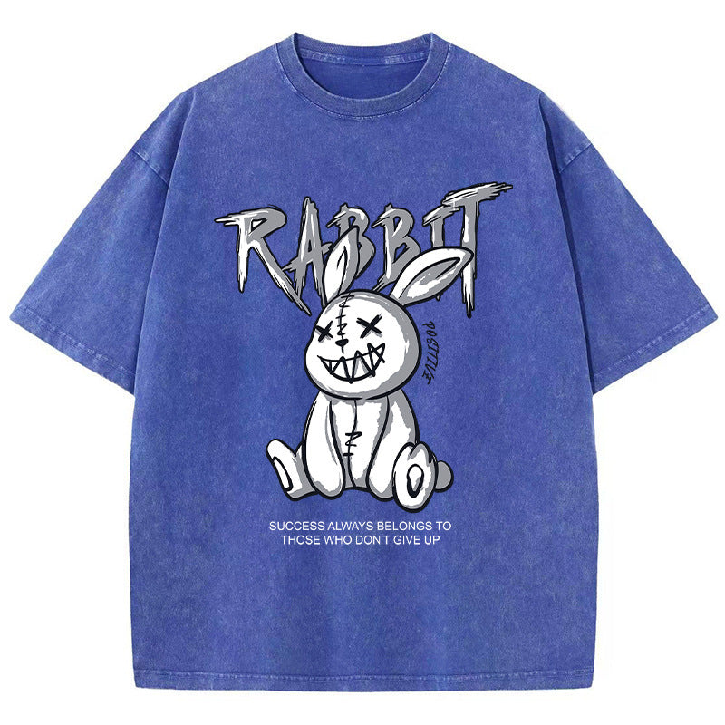 A blue T-shirt featuring a graphic print of a stylized rabbit with the text 'RABBIT' above it. The graphic has a black and white color scheme.