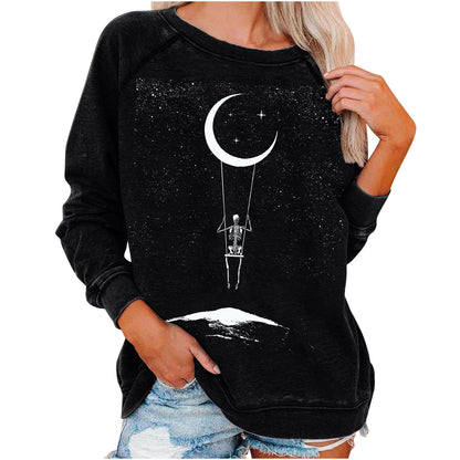 Black sweatshirt with skeleton and moon design worn by a person on a white background