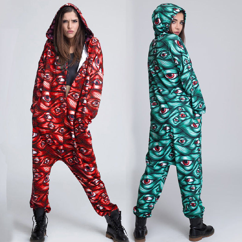 Two people wearing hooded onesies with eye pattern designs on a white background