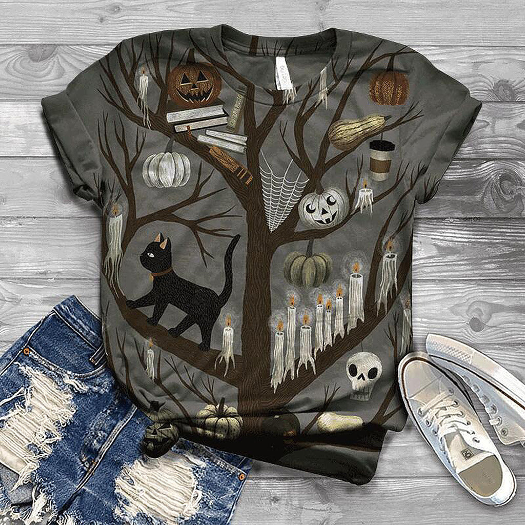 Halloween-themed t-shirt with tree, pumpkins, and black cat design on a wooden surface.