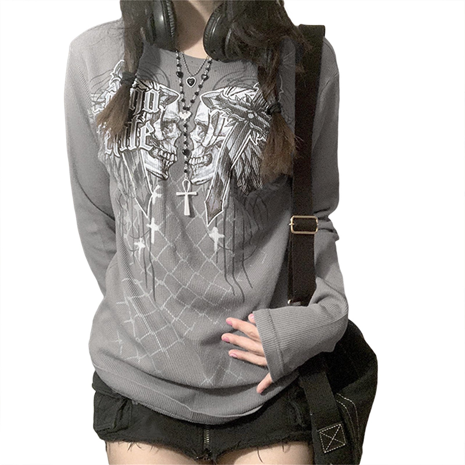 Person wearing a gray hoodie with graphic designs and black shorts on a white background