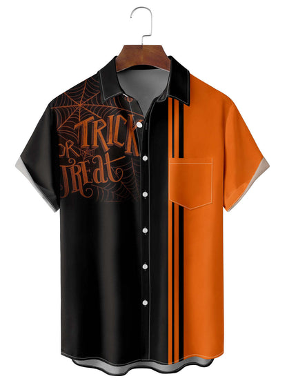 Halloween-themed shirt with black and orange design on a hanger