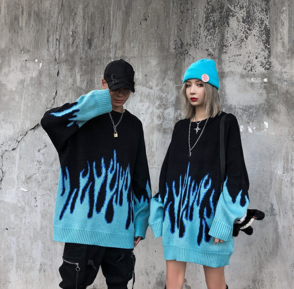 Two individuals wearing black sweatshirts with a blue flame pattern, viewed from the back