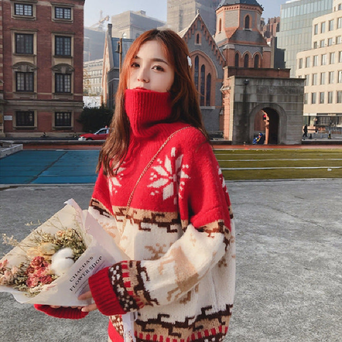 Woman in a red sweater with a patterned design holding flowers in an urban setting