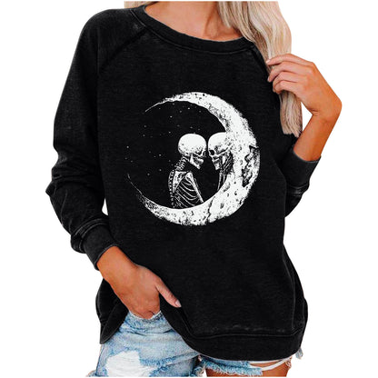 Black sweatshirt with skeleton couple on a moon design, worn by a person.