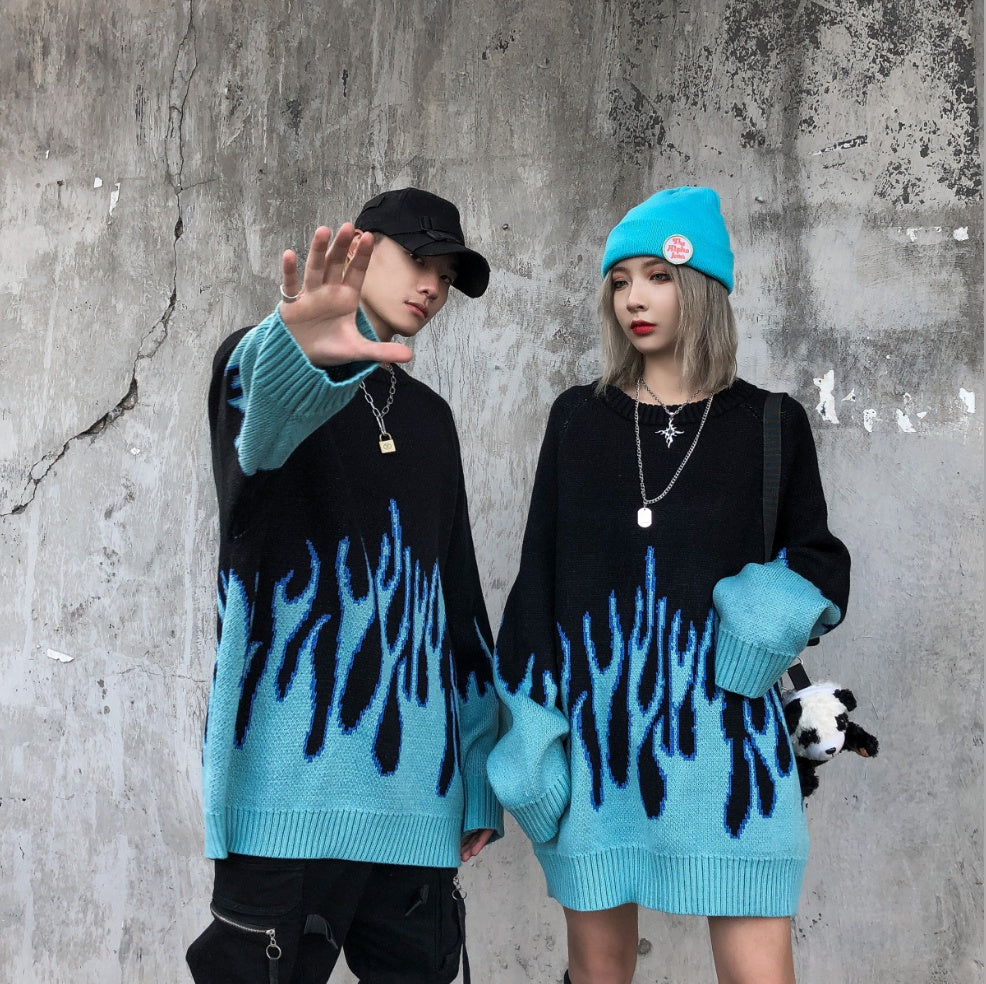 Two individuals wearing black sweatshirts with a blue flame pattern, viewed from the back