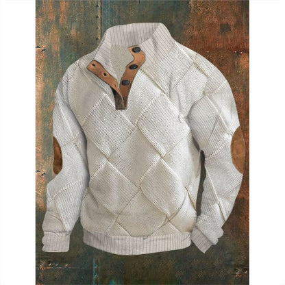 White textured sweater with brown leather patch on a rustic wooden background