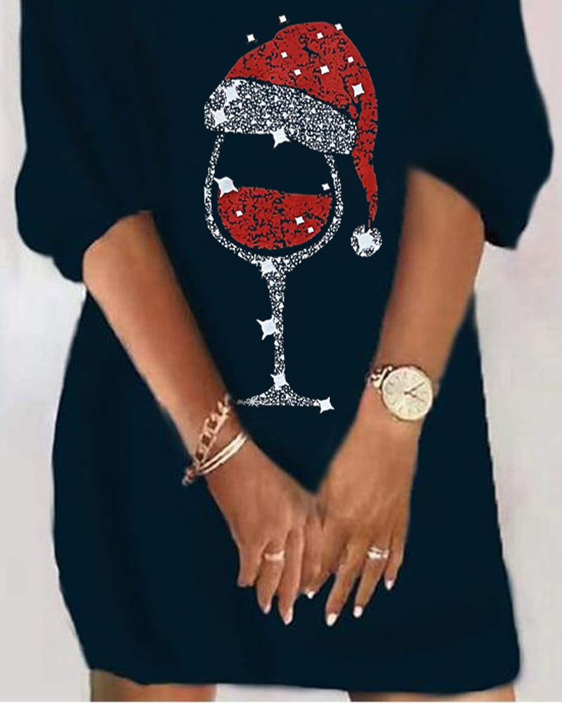 Black dress with a festive wine glass and Santa hat design on a white background