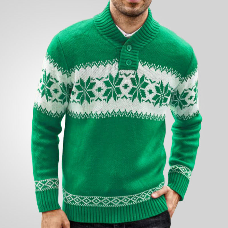 Green sweater with white snowflake pattern worn by a person on a gray background