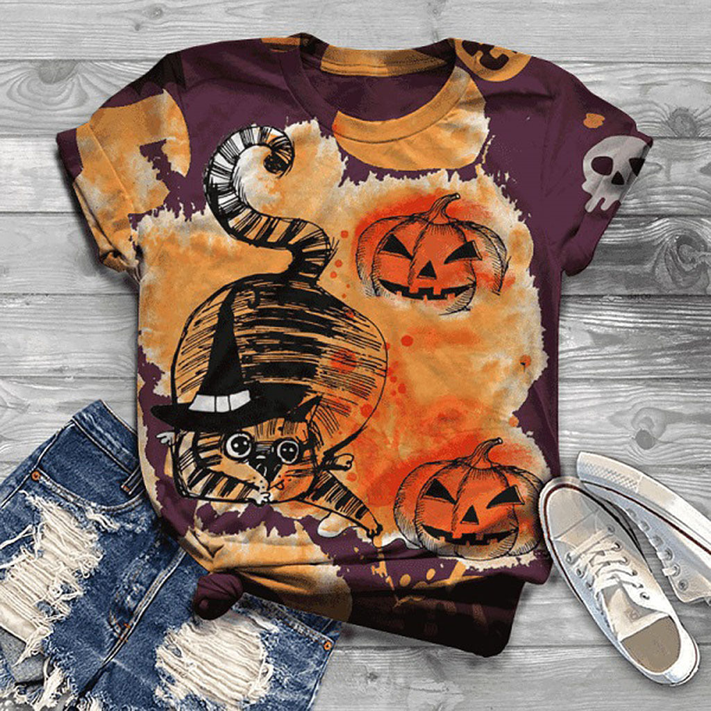 Halloween-themed t-shirt with cat and pumpkin design on a wooden surface with jeans and sneakers.