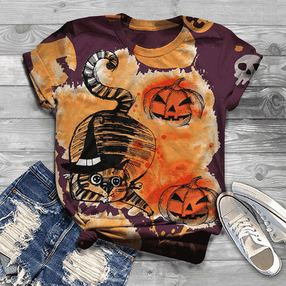Halloween-themed t-shirt with cat and pumpkin design on a wooden surface with jeans and sneakers.