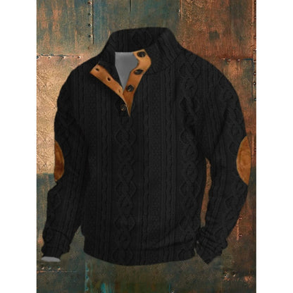 Black cable knit sweater with brown leather accents on a textured background