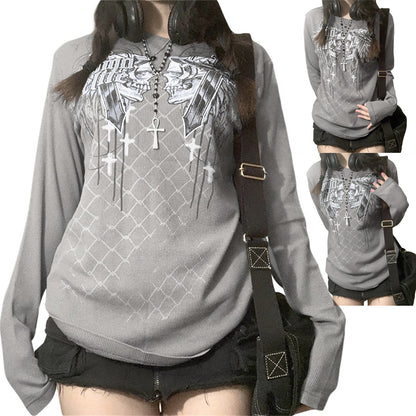 Person wearing a gray hoodie with graphic designs and a black backpack.