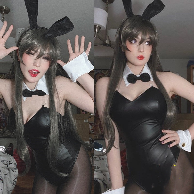 Person wearing a black bunny costume with rabbit ears indoors.