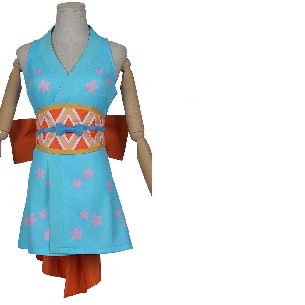 Mannequin wearing a blue dress with pink floral patterns and an orange sash on a white background