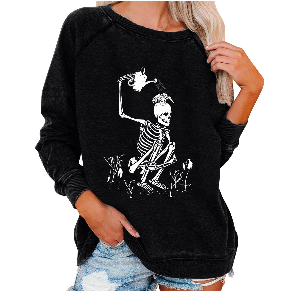 Black sweatshirt with skeleton design worn by a person on a white background