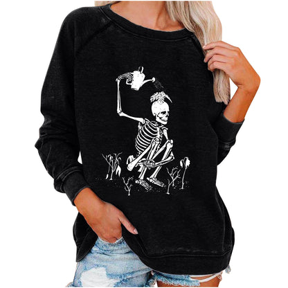 Black sweatshirt with skeleton design worn by a person on a white background
