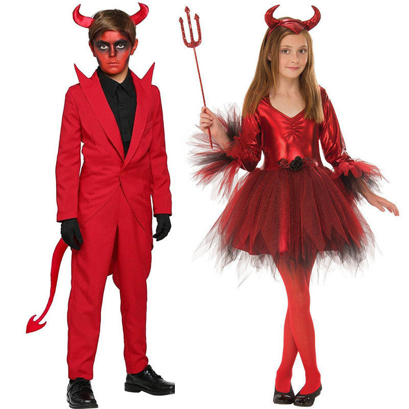 Two children in red devil costumes with horns, tail, and a trident on a white background.