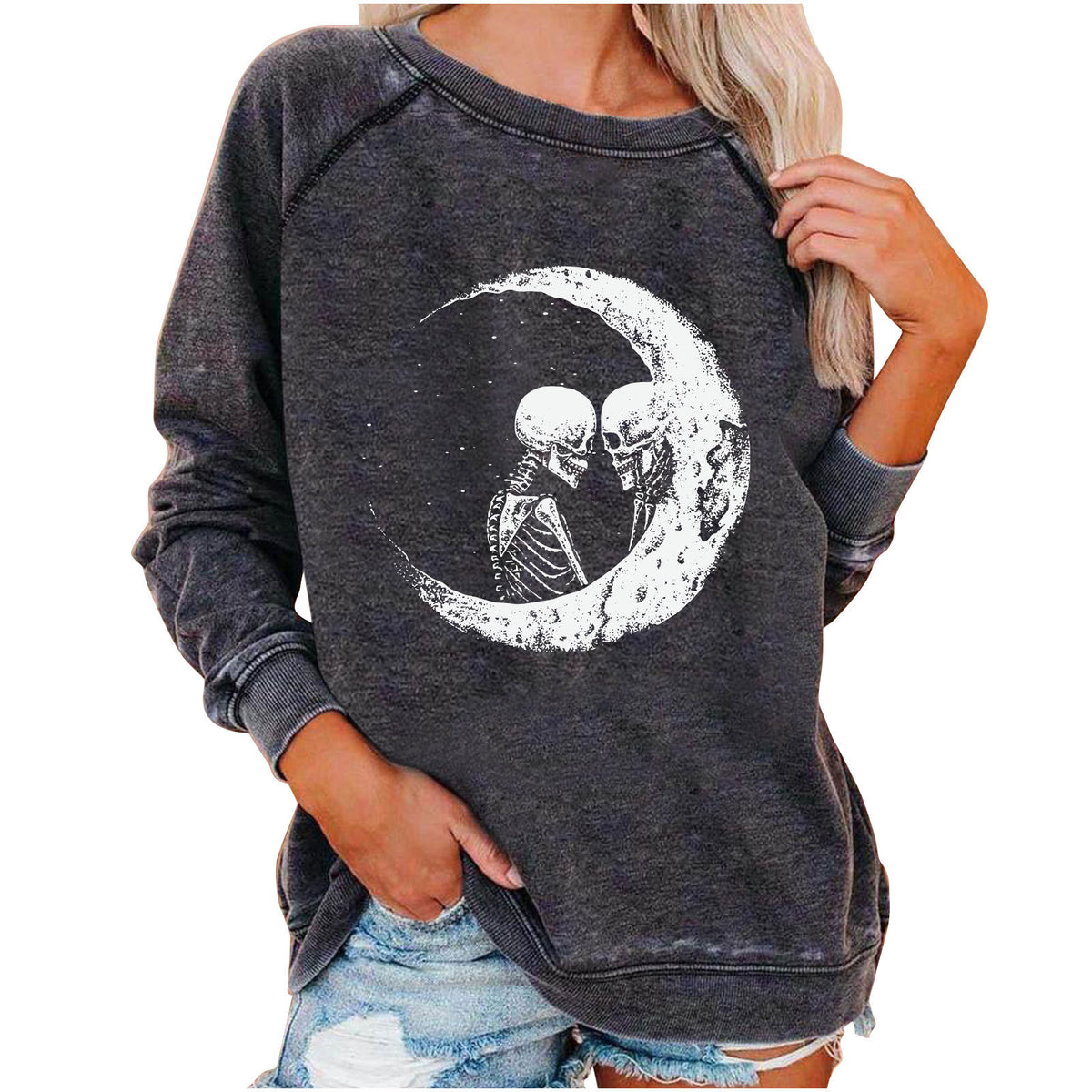 Dark gray sweatshirt with a skeleton couple on a moon design, worn by a person.