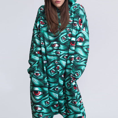 Person wearing a onesie with a unique eye pattern on a plain background
