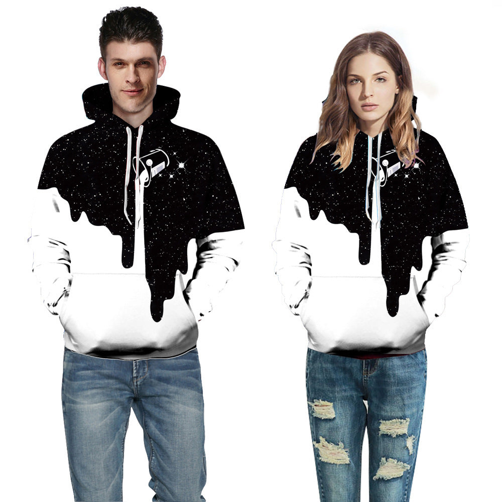 Two people wearing matching black and white hoodies with a design on a white background