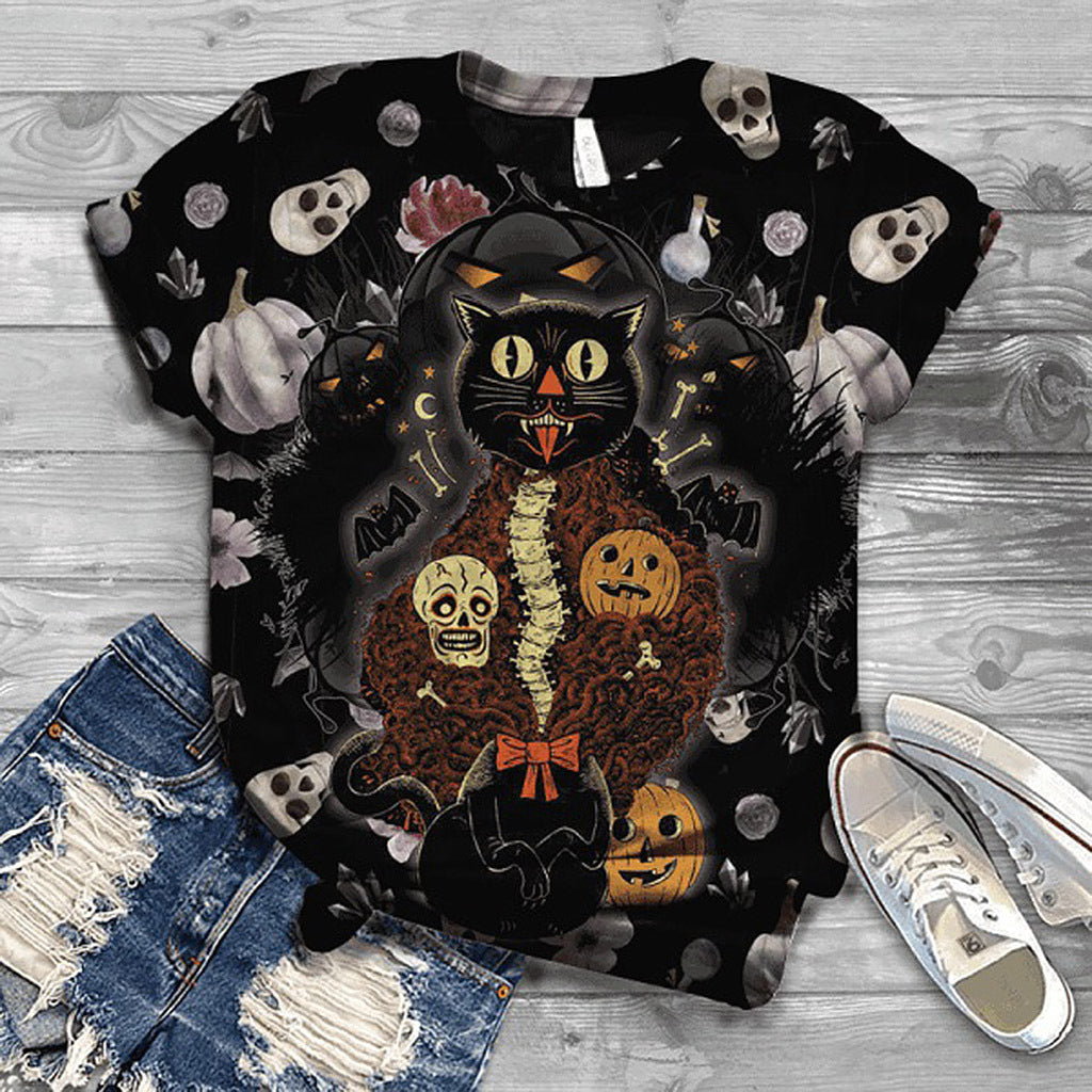 Halloween-themed t-shirt with black cat and pumpkins design on a wooden surface with jeans and sneakers.
