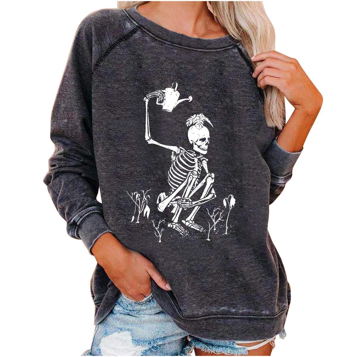 Dark gray sweatshirt with skeleton design worn by a person on a white background