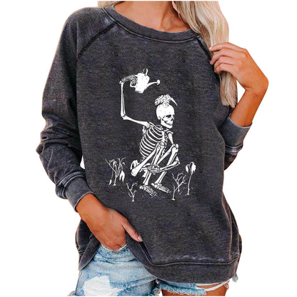 Dark gray sweatshirt with skeleton design worn by a person on a white background